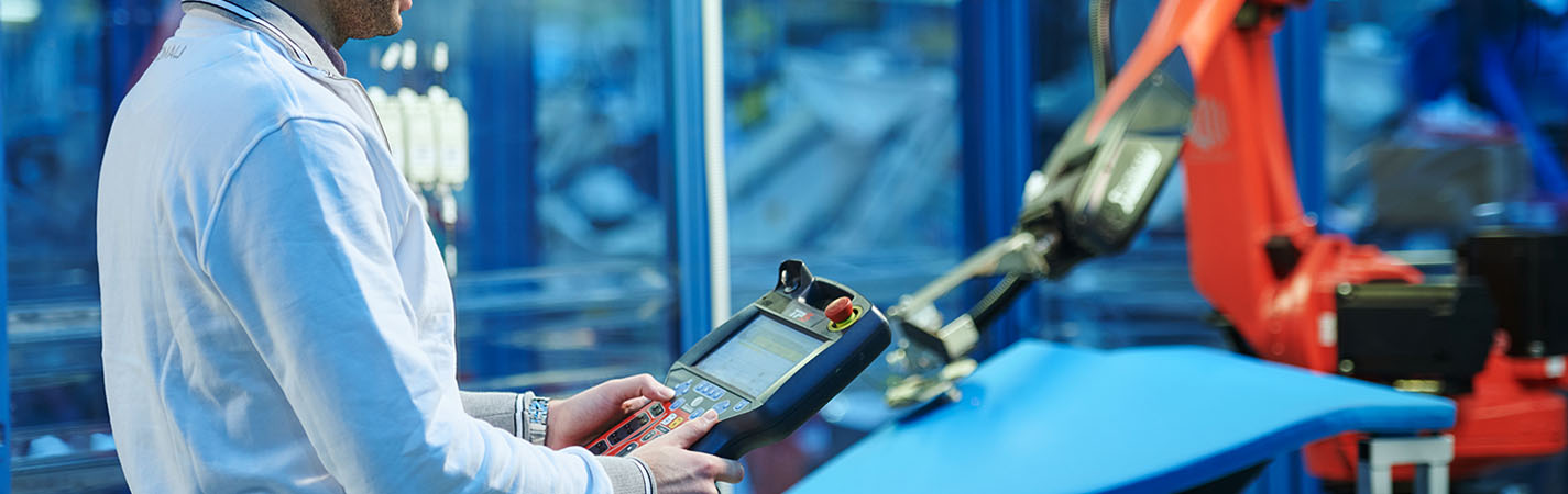 man handling a robot controller